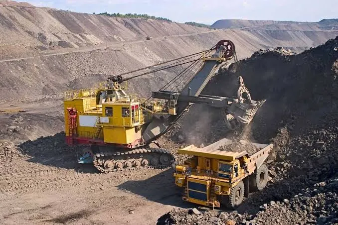 Open-pit mining operation with excavator and haul truck